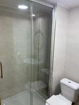 a bathroom with a glass shower with a toilet at Hostal Elkano in Barcelona