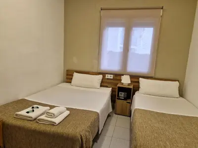 a room with two beds with towels on them at Hostal Elkano in Barcelona