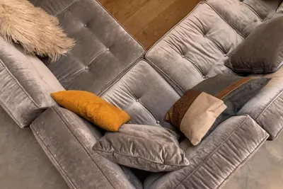 a brown couch with three pillows on it at Petit Luxe Loft in Terrassa