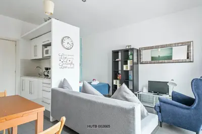 a living room with blue chairs and a table at Alcam Pau Claris in Barcelona