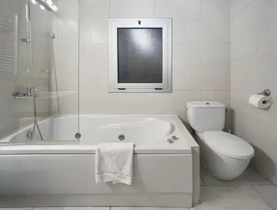 a white bathroom with a tub and a toilet at Stay U-nique Apartments Plaça Universitat in Barcelona