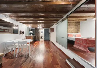 a room with a bed and a table and chairs at Stay U-nique Apartments Plaça Universitat in Barcelona