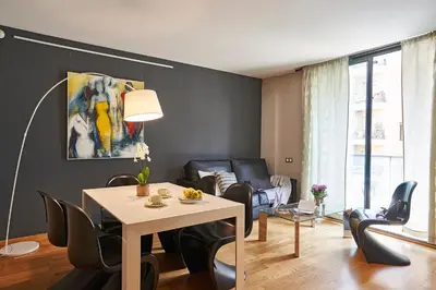 a living room with a table and chairs at AinB Sagrada Familia Apartments in Barcelona