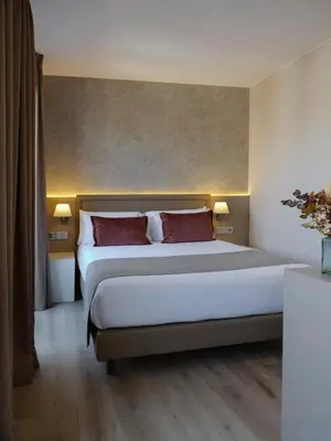 a bedroom with a large bed with red pillows at Musik Boutique Hotel - Solo Adultos in Barcelona