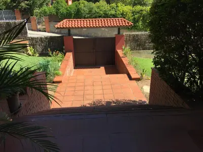 a backyard with a gate and a brick walkway at B&B Inés in Sant Cugat del Vallès