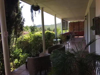 a porch with chairs and a view of the mountains at B&B Inés in Sant Cugat del Vallès