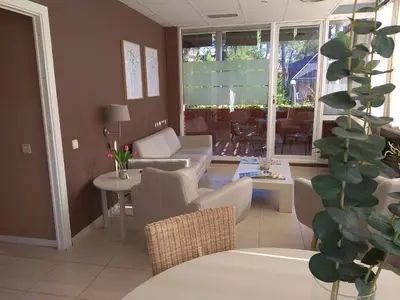 a living room with a couch and chairs and a table at B&B Inés in Sant Cugat del Vallès