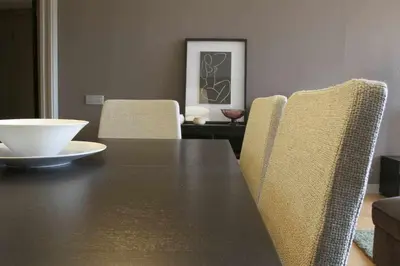 a dining room with a black table and chairs at PASSEIG DE GRACIA SUN APARTAMENT BALCONY / 2 BEDROOMS in Barcelona