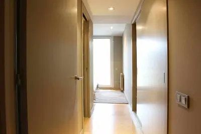 a hallway with a door leading into a room at PASSEIG DE GRACIA SUN APARTAMENT BALCONY / 2 BEDROOMS in Barcelona