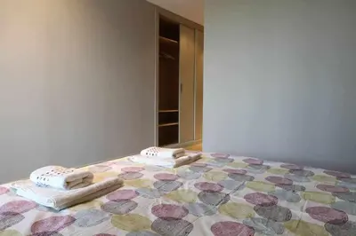 a bedroom with a bed with towels on it at PASSEIG DE GRACIA SUN APARTAMENT BALCONY / 2 BEDROOMS in Barcelona