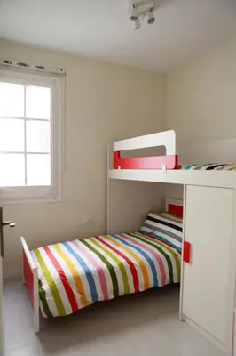 a childs bedroom with a bunk bed and a window at Barcelona Family Beach in Barcelona