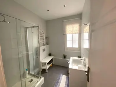 a white bathroom with a sink and a shower at Barcelona Family Beach in Barcelona
