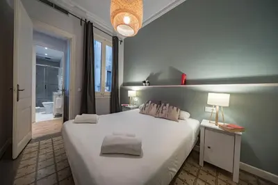 a bedroom with a white bed with two pillows on it at Habitat Apartments Alaia in Barcelona