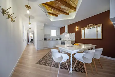 a kitchen and dining room with a table and chairs at Habitat Apartments Grace in Barcelona