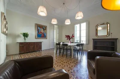 a living room with a couch and a table with chairs at SibsBcn- Rambla- Family Friends Business Central in Barcelona