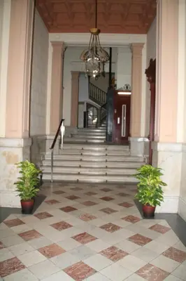 a lobby with stairs and potted plants and a chandelier at SibsBcn- Rambla- Family Friends Business Central in Barcelona