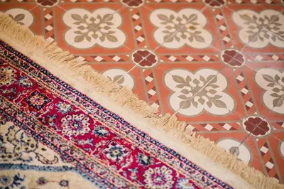 a close up of a rug in front of a tile wall at Hotel Torre Barcelona in Sant Cugat del Vallès