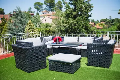 a patio with a table and chairs on the grass at Hotel Torre Barcelona in Sant Cugat del Vallès