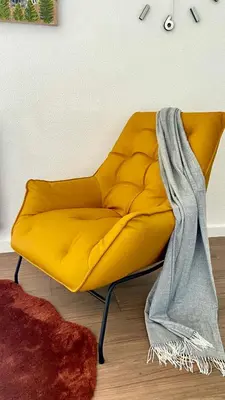 a yellow couch with a blanket on top of it at Sants Estación acogedor apartamento en Exiample in Barcelona