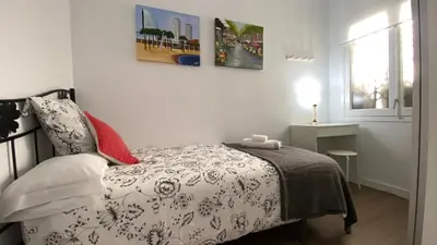 a small bedroom with a bed and a window at Sants Estación acogedor apartamento en Exiample in Barcelona