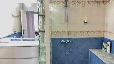 a bathroom with a shower with a blue tile at Sants Estación acogedor apartamento en Exiample in Barcelona