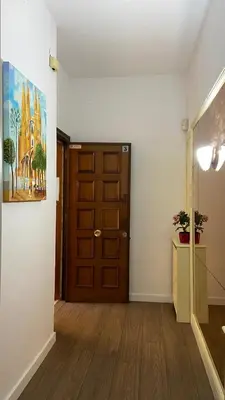 a room with a door and a hallway with wood floors at Sants Estación acogedor apartamento en Exiample in Barcelona
