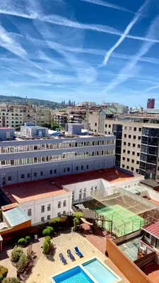 a large building with a tennis court on top of it at Sants Estación acogedor apartamento en Exiample in Barcelona