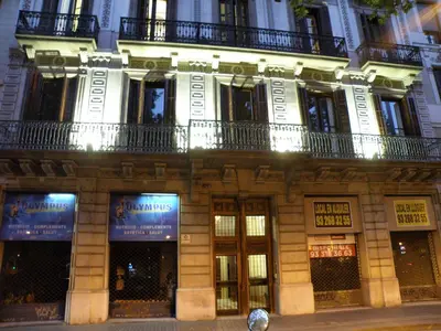 a large building with a balcony on the side of it at Hotel Center Gran Via in Barcelona