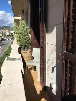 a white chair sitting on the side of a building at Habitació amb encant in Sitges