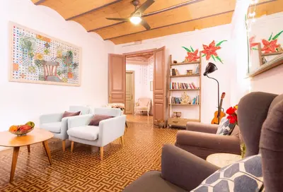 a living room with couches and chairs and a table at Primavera Hostel in Barcelona