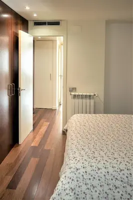 a bedroom with a bed and a door to a hallway at Apartamento Via Augusta 153 in Barcelona