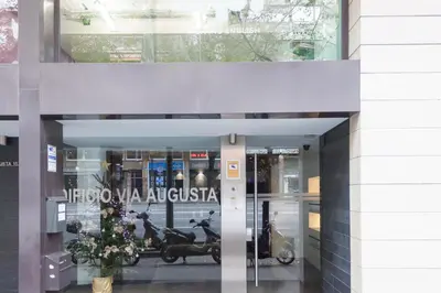 a entrance to a building with a scooter in the window at Apartamento Via Augusta 153 in Barcelona