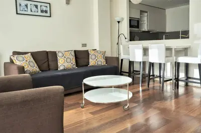 a living room with a couch and a table at Apartamento Via Augusta 153 in Barcelona