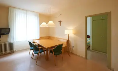 a dining room with a table and chairs and a window at Apartamentos Montserrat Abat Marcet in Montserrat
