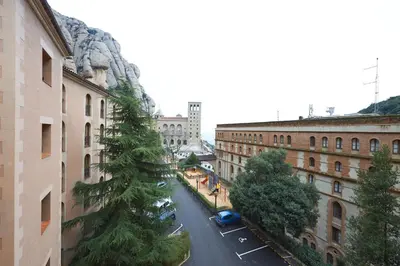a view of a city street with a pine tree at Apartamentos Montserrat Abat Marcet in Montserrat