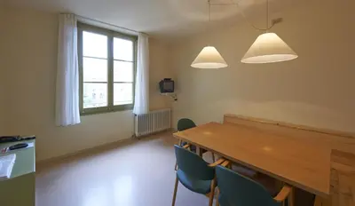 a dining room with a wooden table and chairs at Apartamentos Montserrat Abat Marcet in Montserrat