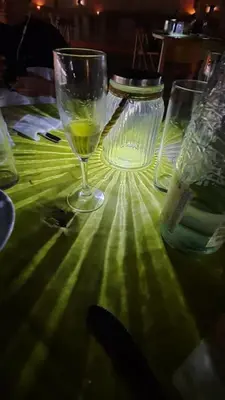 a glass of wine sitting on top of a table at Hotel Fonda Neus in Sant Sadurní dʼAnoia
