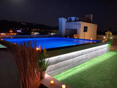a swimming pool lit up at night with lights at Hotel Fonda Neus in Sant Sadurní dʼAnoia
