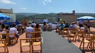a group of people sitting in chairs on a patio at Hotel Fonda Neus in Sant Sadurní dʼAnoia