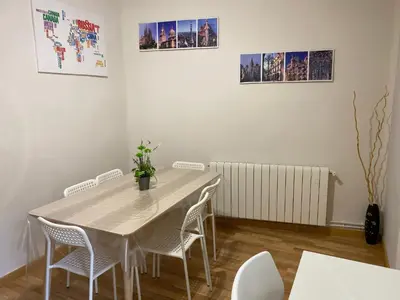 a dining room with a table and chairs at Comfortable renovated flat, WiFi! in Badalona