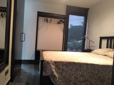 a bedroom with a bed and a window at VILLA DEL BOSQUE in Castelldefels