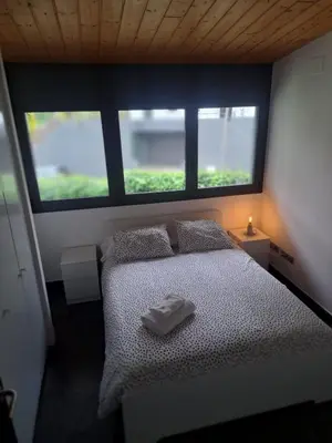 a bedroom with a bed with two pillows and a window at VILLA DEL BOSQUE in Castelldefels