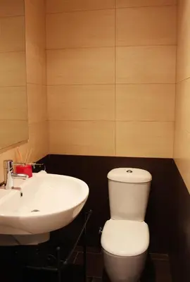a bathroom with a white toilet and a sink at Sitges Ático 2 min a Playa San Sebastían in Sitges