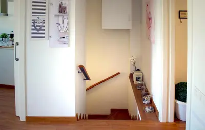 a hallway with a staircase with a white door at Sitges Ático 2 min a Playa San Sebastían in Sitges
