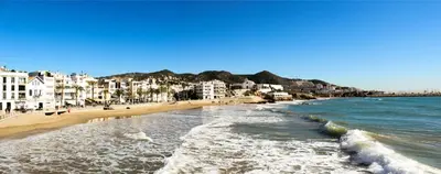 a view of a beach with buildings and the ocean at Sitges Ático 2 min a Playa San Sebastían in Sitges