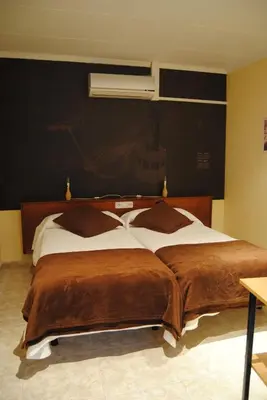 a bedroom with a large bed with brown blankets at Guilleumes Montserrat in Monistrol