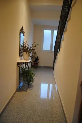 a hallway with stairs and a mirror and plants at Guilleumes Montserrat in Monistrol