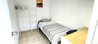 a small bedroom with a small bed in the corner at Pintor Pahissa Rooms in Barcelona
