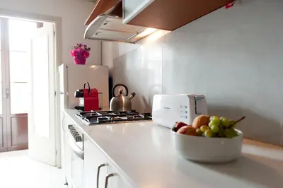 a kitchen with a bowl of fruit on a counter at MH Apartments Ramblas in Barcelona