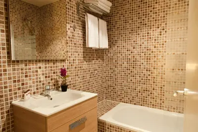 a bathroom with a sink and a bath tub at MH Apartments Ramblas in Barcelona